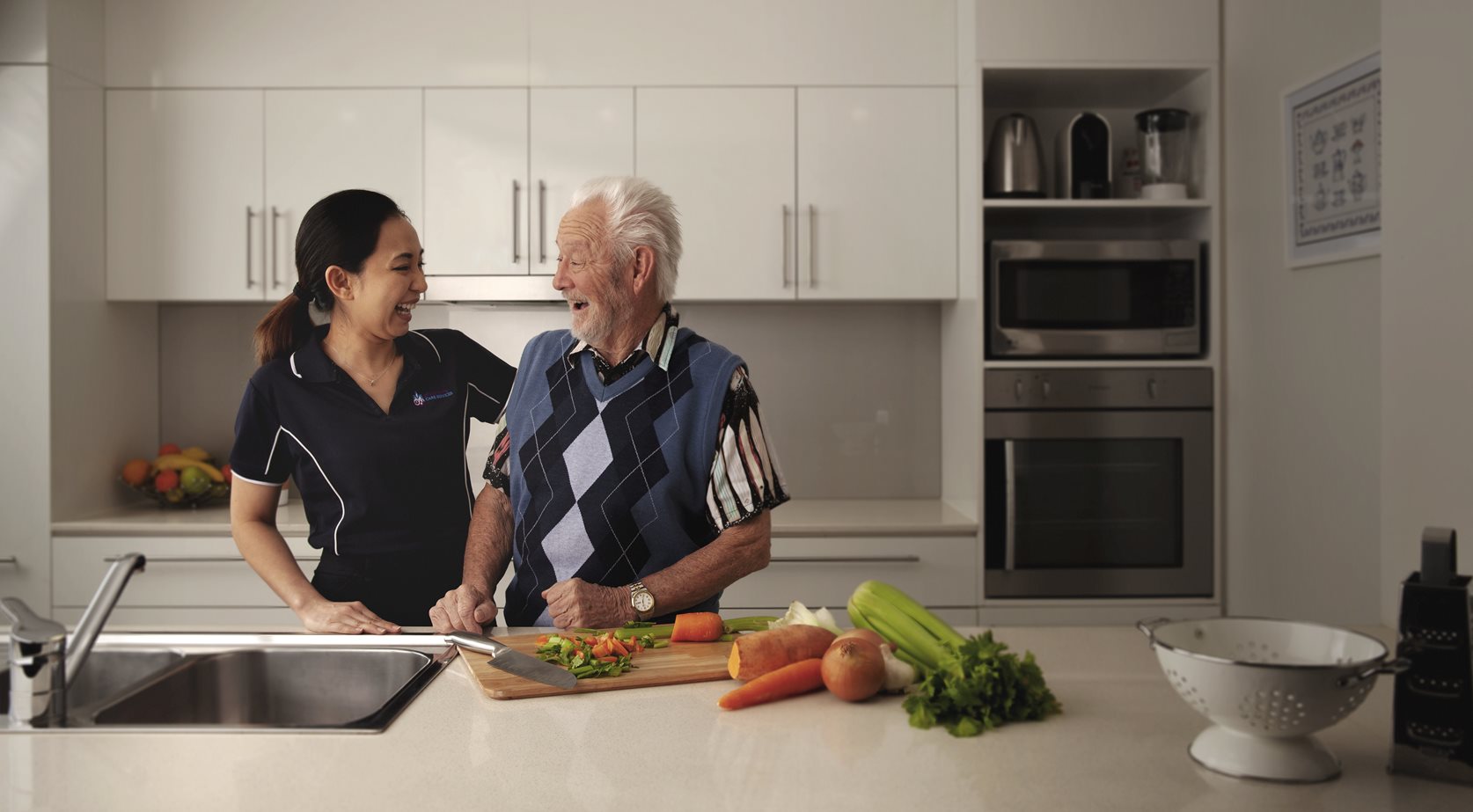 a home care worker in the kitchen with a client